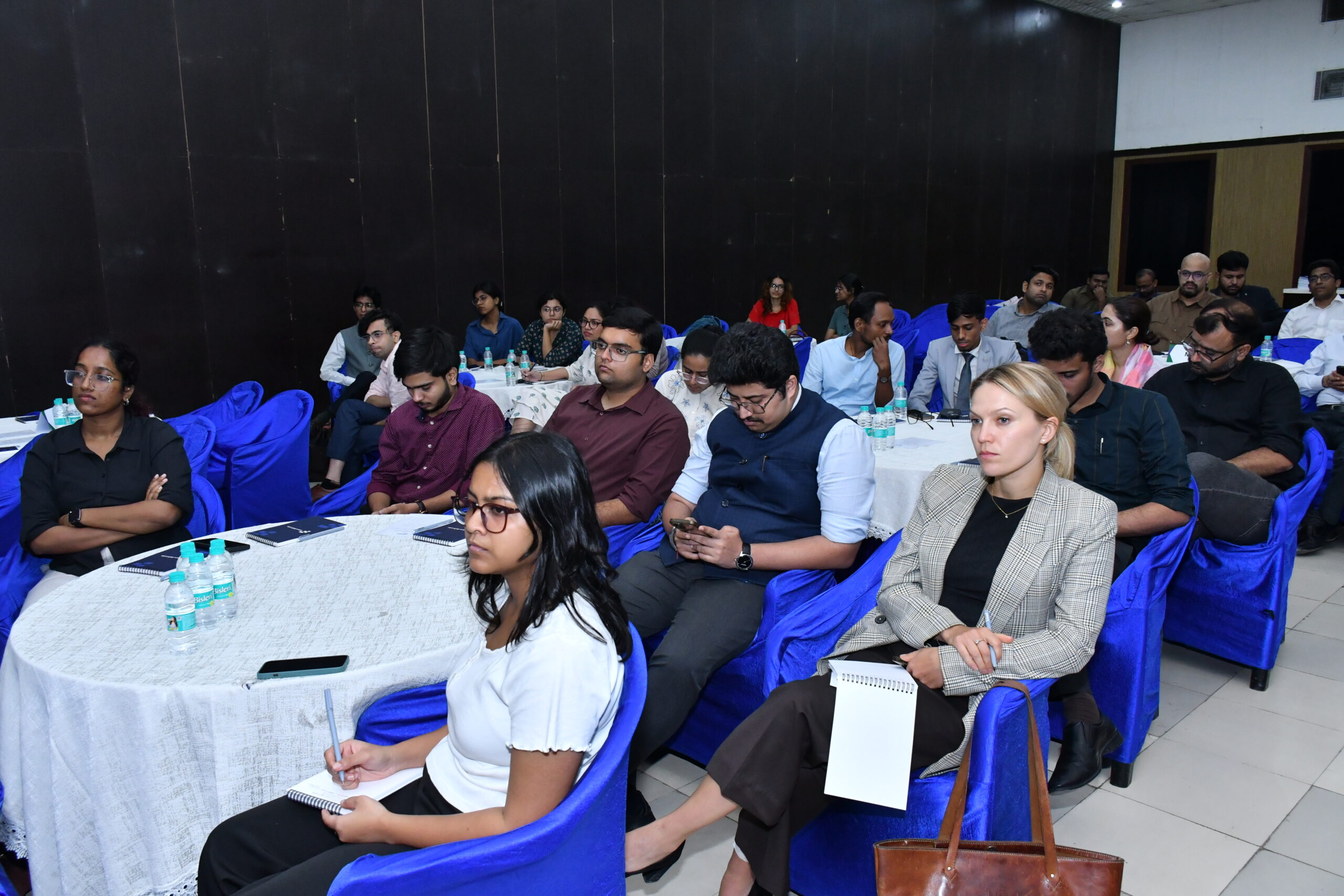 Attendees listening at a conference.
